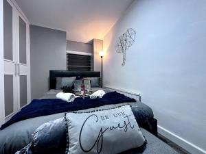 a bedroom with a bed with a sign on it at Gorgeous Graceful Getaway w/ Gazebo - Tylorstown in Llwyn-y-pia