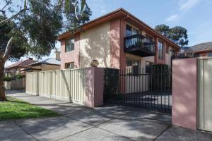 a pink and white house with a fence at Northcote Charm Spacious and Quiet Suburban Stay in Melbourne