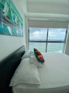 a bedroom with a bed with a large window at Apartamentos Cartagena Oceano - Eliptic in Cartagena de Indias