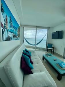 a living room with a white couch and a table at Apartamentos Cartagena Oceano - Eliptic in Cartagena de Indias