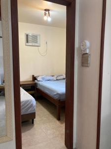 En eller flere senge i et værelse på Residencial Oliveira - Casas na Praia da Ferrugem
