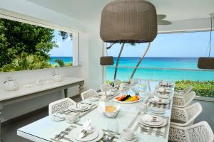 a dining room with a table and a view of the ocean at FOOTPRINTS by DC in Saint James