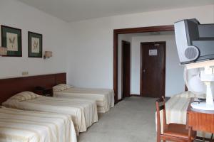 TV a/nebo společenská místnost v ubytování Residencial Greco