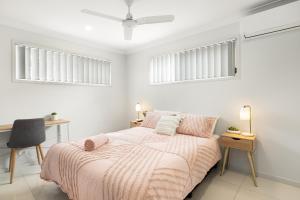 a white bedroom with a bed and two windows at Air-Con, Netflix, Close to Transport & Private in Brisbane