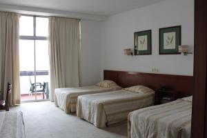 Postel nebo postele na pokoji v ubytování Residencial Greco