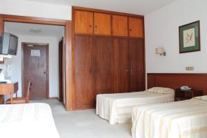 Postel nebo postele na pokoji v ubytování Residencial Greco