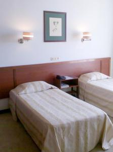 Postel nebo postele na pokoji v ubytování Residencial Greco