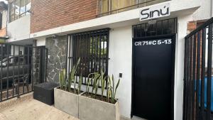 a snu storefront with a black door on a building at SINU LOFT in Medellín