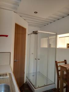 a glass shower in the corner of a room at CASA V - Mizata in Santa María Mizata