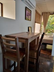 a wooden table and chairs in a room with a bed at CASA V - Mizata in Santa María Mizata