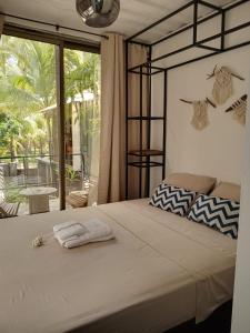 a bed with two towels on it in a bedroom at CASA V - Mizata in Santa María Mizata