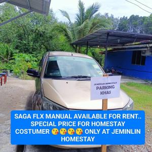 a sign on a car parked in front of a house at Jeminlin homestay, budget price in Kota Kinabalu