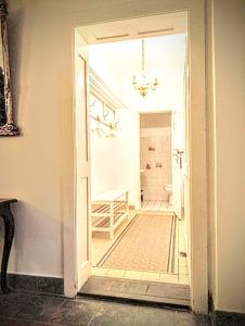 an open door to a hallway with a bathroom at Ferienhaus Dr. Müller in Meißen