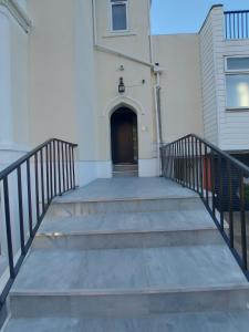 a set of stairs leading to a building with a door at Inn By The Sea, Portsmouth - EN SUITE Rooms with or without Sea View in Portsmouth