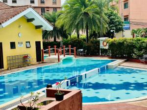 a large swimming pool with blue water in front of a building at Avida Tower Sucat, comfortable studio type in Manila