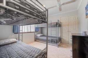 a bedroom with two bunk beds and a desk at Gem on Jones in Vasse