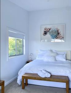 a bedroom with blue walls and a bed with a bench at The View @ Ulandi in Lowther