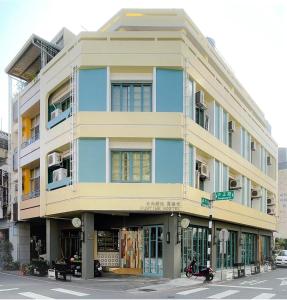 a building on the corner of a street at Funtime Hostel in Chiayi City