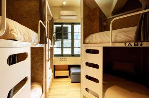 a dorm room with two bunk beds in it at Funtime Hostel in Chiayi City