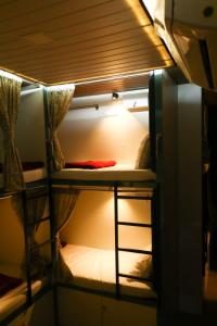 a bunk bed with a ladder in a room at Dormitory Hub in Mumbai