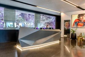 a lobby with a large glass wall with a table at Crystalbrook Vincent in Brisbane