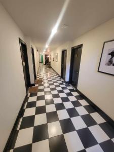 a hallway with a black and white checkered floor at Modern Unit! Just steps away from Greenville Ave! in Dallas