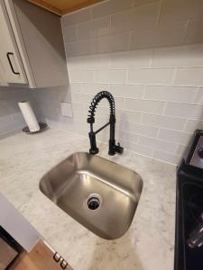 a kitchen counter with a sink in a kitchen at Modern Unit! Just steps away from Greenville Ave! in Dallas