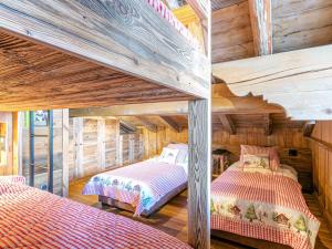 two bunk beds in a room with wooden walls at Appartement Val-d'Isère, 5 pièces, 10 personnes - FR-1-694-334 in Val-d'Isère
