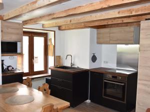 a kitchen with a sink and a table with a tableablish at Chalet Pralognan-la-Vanoise, 3 pièces, 4 personnes - FR-1-464-219 in Pralognan-la-Vanoise