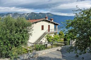 une maison blanche avec des escaliers sur son côté dans l'établissement Apartment in Tignale with Lake Garda Views, à Tignale