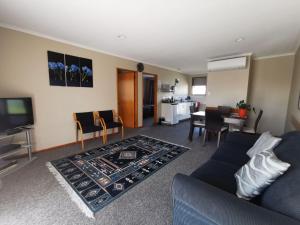 a living room with a couch and a dining room at Broadview Motel in Cheviot