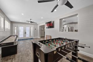 a room with a foosball table and a ceiling fan at Relaxing Old Town Scottsdale desert oasis awaits in Scottsdale