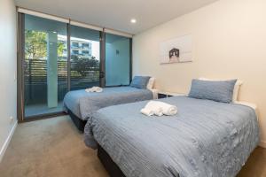 Кровать или кровати в номере Strand Beachside 104 +11 фотографий