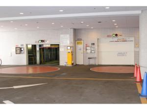 an empty parking lot with a large door in a building at Rembrandt Hotel Tokyo-Machida in Machida