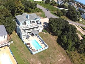 an aerial view of a house with a swimming pool at No Fee Luxury Pet Friendly 7BR Soundfront retreat with Elevator, Heated Pool and Hot Tub in Kitty Hawk