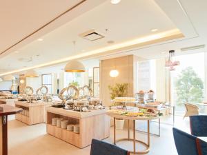 a restaurant with counters and tables with food at Rembrandt Hotel Tokyo-Machida in Machida