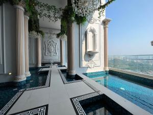 a swimming pool in a building with a large window at Arte Cheras Designer Suite by Moka @ Cheras in Kuala Lumpur