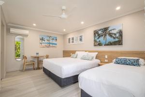 Habitación de hotel con 2 camas y mesa en Seagulls en Townsville