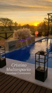 a view of a swimming pool with a sunset in the background at Cristino Multiespacio in Goya