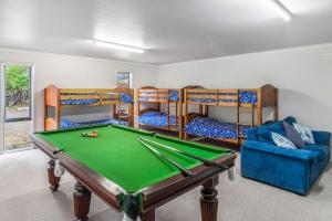a room with a pool table and bunk beds at Mirimvale - Base of Mt Buller - Sleeps 14 in Merrijig