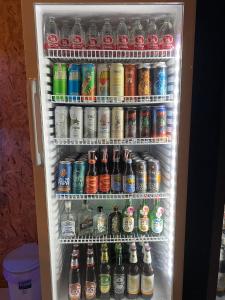 a refrigerator filled with lots of different types of drinks at Tid Khao Glamping & Bar in Tha Kradan