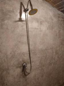 a shower in a room with a concrete floor at Tid Khao Glamping & Bar in Tha Kradan