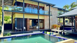 an external view of a house with a swimming pool at Allawah Port Douglas in Port Douglas
