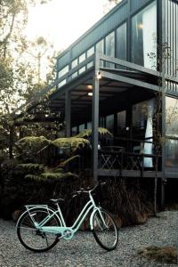 a bike parked in front of a building at The Estate Hulu Rening - Private Retreat Cabin in Batang Kali