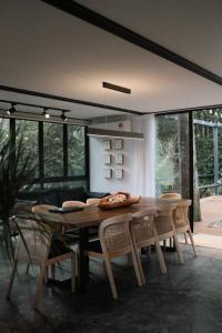 a dining room with a wooden table and chairs at The Estate Hulu Rening - Private Retreat Cabin in Batang Kali