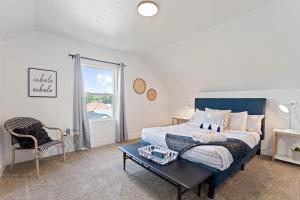 a bedroom with a bed and a table and a window at Big House Mins To DT Big Groups Well Stocked in Spokane