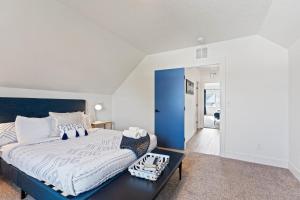 a bedroom with a large bed and a table at Big House Mins To DT Big Groups Well Stocked in Spokane