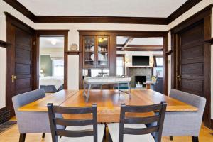 a dining room with a wooden table and chairs at Perry District Superb Quality Perfect Location in Spokane