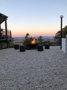 a fire pit with a view of the sunset at The View @ Ulandi in Lowther
