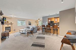 a living room and kitchen with a couch and chairs at Modern Amenities Gas Fireplace Central Location in Spokane